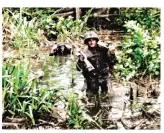  ??  ?? Marines wade through a river during the Battle of Coconut Grove on Bougainvil­le in November 1943. Note the Raider in front is shoulderin­g a .30cal Browning machine gun plus his rifle