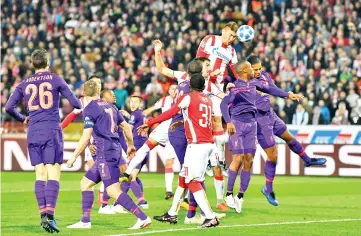  ??  ?? Red Star Belgrade’s Serbian forward Milan Pavkov (3R) heads the ball and scores a goal during the UEFA Champions League Group C second-leg football match between Red Star Belgrade and Liverpool FC at the Rajko Mitic Stadium in Belgrade. - AFP photo