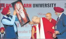  ?? KESHAV SINGH/HT ?? Chandigarh University chancellor Satnam Singh Sandhu presents a portrait of Guru Nanak to the Dalai Lama in Gharuan, Mohali, on Tuesday.