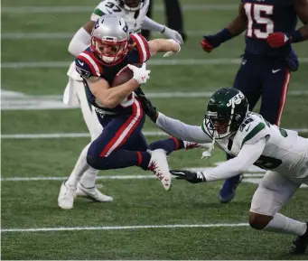  ??  ?? BREAKING FREE: Patriots wideout Gunner Olszewski leaps past Jets cornerback Lamar Jackson during the third quarter on Sunday.