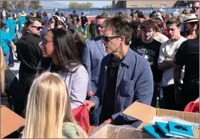  ?? In this photo provided by Jesse Sorenson, Footloose actor Kevin Bacon, center, helps fill care packages for his charity, Saturday, in Payson, Utah ??