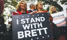  ?? Bloomberg photo by Andrew Harrer ?? Women hold signs in support of Supreme Court nominee Brett Kavanaugh while demonstrat­ing ahead of a Senate Judiciary Committee hearing on Thursday.