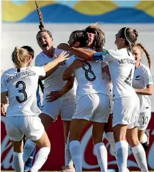  ?? GETTY IMAGES ?? Amelia Abbott (No 8) is congratula­ted by her New Zealand team-mates after scoring the opening goal against Japan.