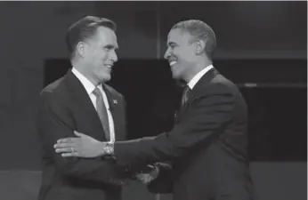  ?? WIN MCNAMEE/GETTY IMAGES ?? Barack Obama shares a friendly moment with Mitt Romney during the presidenti­al debate Wednesday night.