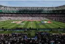  ?? Photograph: Tom Jenkins/The Guardian ?? The England and France women’s teams line up for the national anthems at Twickenham in front of 58,498 spectators.