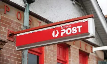  ?? Photograph: Ryan Pierse/ Getty Images ?? Australia Post paid $28.2m in bonuses to hundreds of senior managers earning over $200,000 a year in 2019-20.