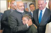  ?? PTI ?? PM Narendra Modi hugs Moshe Holtzberg, one of the survivors of the 26/11 Mumbai terror attack, in Jerusalem on Wednesday.