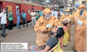  ??  ?? Health workers administer SARS-COV-2 tests at a railway station in Sri Lanka’s capital Colombo.credit: Xinhua/eyevine