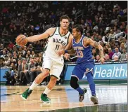  ?? STACY REVERE PHOTOS / GETTY IMAGES ?? Brook Lopez, an 11-year veteran (shown here being guarded by the Knicks’ Trey Burke), spent his first nine seasons with the Nets after being drafted 10th overall out of Stanford in 2008. But he didn’t hit his first 3 until Jan. 10, 2015, when he was 1 for 2 in a 98-93 loss to the Detroit Pistons.