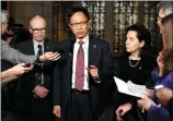  ?? CP PHOTO JUSTIN TANG ?? Sen. Yuen Pau Woo, facilitato­r of the Independen­t Senators Group, speaks to reporters along with Sen. Tony Dean, left, and Sen. Raymonde Saint-Germain, following a vote on Bill C-45, the Cannabis Act, on Parliament Hill in Ottawa on Thursday.