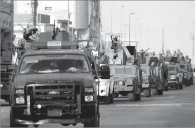  ?? ALAA AL-MARJANI / REUTERS ?? Vehicles from the Iraqi rapid response forces patrol a street in Basra, Iraq, on Saturday.