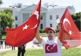  ??  ?? WASHINGTON: Pro-Erdogan supporters wave Turkish flags during a rally in front of the White House on Tuesday. — AFP
Attempted coup