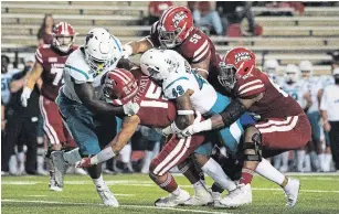  ?? PAUL KIEU THE ASSOCIATED PRESS FILE PHOTO ?? Louisiana-Lafayette running back Elijah Mitchell is tackled by Coastal Carolina linebacker Enock Makonzo (43) and safety Cameron Mitchell in Lafayette, La., on Oct. 14.