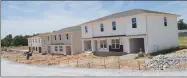  ?? Westside Eagle Observer/MIKE ECKELS ?? Three duplexes in the new Sycamore Acres subdivisio­n on the west side of Decatur are in various stages of completion, with the unit on the right almost finished. Forty-two 2-family dwellings are planned for this Decatur complex.