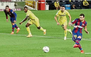  ??  ?? Bullseye: Barcelona’s Lionel Messi scoring a penalty against Villarreal during the La Liga match at the Nou Camp. — Reuters