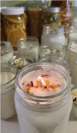  ?? ?? If you want, add some dried flowers to the top of your candle wax.