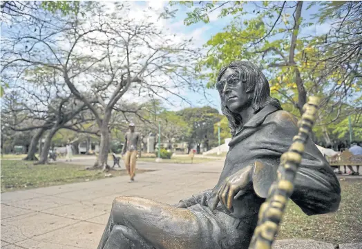  ??  ?? IMAGINE THAT: A statue of the late ex-Beatle John Lennon in a park in Havana. A guard prevents people from stealing his spectacles.