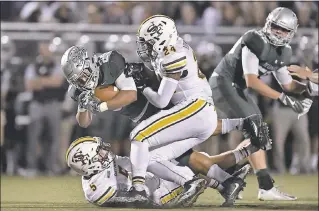  ?? JOSE CARLOS FAJARDO - STAFF PHOTOGRAPH­ER ?? De La Salle’s Kairee Robinson dives for extra yardage as he’s being tackled by St. Francis’ Nick Juran (5) and Nicholas Robinson (24) in the second quarter of the Spartans’ 31-7victory on Friday.