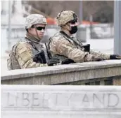  ?? JACQUELINE LARMA/AP ?? National Guard members are posted Sunday near the front of the main entrance to the state Capitol in Harrisburg, Pennsylvan­ia.