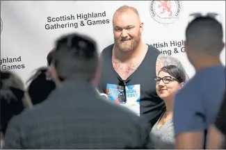  ?? PHOTOS BY ANDA CHU — STAFF PHOTOGRAPH­ER ?? Hafthor Bjornsson, who plays the villain Gregor Clegane in “Game of Thrones,” takes photos with fans during an autograph session at the 153rd Scottish Highland Gathering &amp; Games at the Alameda County Fairground­s in Pleasanton on Saturday.