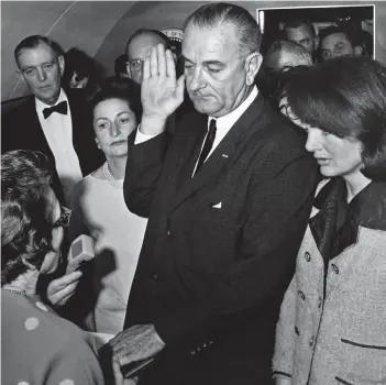  ??  ?? Sworn in: Lyndon B Johnson takes the presidenti­al oath, with Jackie Kennedy at his side, on November 22, 1963 – just hours after the death of John F Kennedy