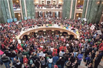  ?? MILWAUKEE JOURNAL SENTINEL FILES ?? Thousands pack the state Capital in Madison in February 2011 to protest Gov. Scott Walker's Act 10, which placed severe limits on public unions.