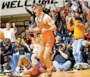  ?? [PHOTO BY BRUCE WATERFIELD, OSU ATHLETICS] ?? Oklahoma State’s Chandler Rogers, shown here in a Bedlam match against Oklahoma, pinned both of his opponents Thursday at the NCAA Wrestling Tournament in St. Louis.