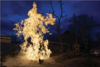  ?? EVGENIY MALOLETKA — THE ASSOCIATED PRESS ?? A rescue worker puts out the fire of a destroyed gas distributi­on point in a residentia­l neighborho­od in Ukraine after Russian attack in Kostiantyn­ivka on Monday.