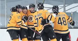  ?? DAVID BUTLER II/USA TODAY SPORTS ?? Bruins center Brad Marchand (63) celebrates one of his three goals with teammates during Saturday’s win.