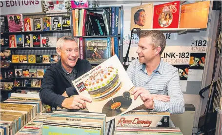  ?? Picture: Steve MacDougall. ?? Owner Garry Smith, left, and son Craig, manager, check out some vinyl.