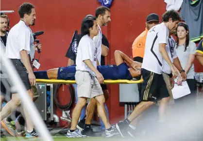  ??  ?? Marco Asensio has his head in his hands as he is carried from the pitch. Photograph: Erik S Lesser/EPA