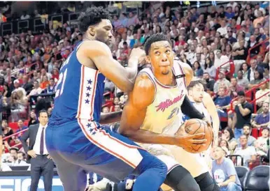  ?? CHARLES TRAINOR JR/MIAMI HERALD ?? Miami’s Hassan Whiteside, right, will be squaring off again against the 76ers’ Joel Embiid, left, provided the Philly center comes back from his injury.