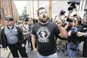  ?? STEVE HELBER / AP ?? Matthew Heimbach (center) voices his displeasur­e at the media after a court hearing for James Alex Fields Jr., in front of court in Charlottes­ville, Va., Monday. A judge has denied bond for Fields, who is accused of plowing his car into a crowd at a...