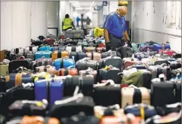  ?? Christina House Los Angeles Times ?? DURING Southwest’s meltdown, more than 15,000 flights were canceled. Wouldbe passengers missed holiday celebratio­ns and were separated from their baggage.