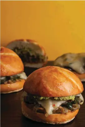  ?? [PHOTO BY BY GORAN KOSANOVIC, FOR THE WASHINGTON POST/FOOD STYLING BY BONNIE BENWICK, THE WASHINGTON POST] ?? Mushroom Poblano and Refried Bean Tortas