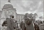  ?? Ap-jeff Amy, File ?? In this March 25 file photo, African Methodist Episcopal Church Bishop Reginald Jackson announces a boycott of Coca-cola Co. products outside the Georgia Capitol in Atlanta. Jackson says Coca-cola and other large Georgia companies haven’t done enough to oppose restrictiv­e voting bills that Georgia lawmakers were debating as Jackson spoke