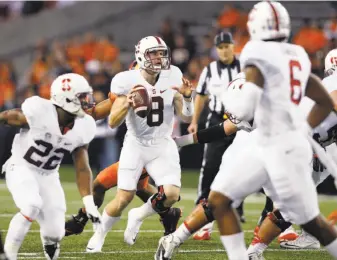  ?? Timothy J. Gonzalez / Associated Press ?? Kevin Hogan (8), who sprained an ankle against USC, was 9-for-14 for 163 yards and two TDs.