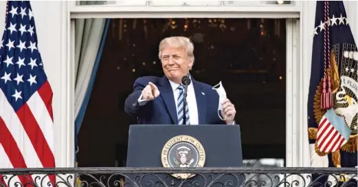  ?? SAMUEL CORUM/GETTY IMAGES ?? ABOVE: President Donald Trump points to supporters Saturday during his speech from a White House balcony.