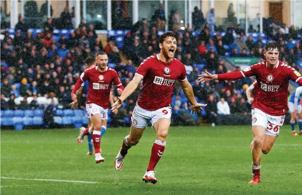  ?? ?? Chris Martin, centre, shows his delight after scoring Bristol City’s third goal in the win at Peterborou­gh on Saturday