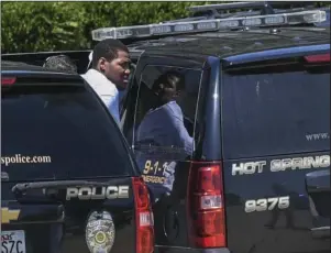  ?? The Sentinel-Record/Grace Brown ?? STANDOFF: Hot Springs Police place Willie James Taylor, of Illinois, into a marked unit following a brief standoff in one of the rooms at the SunBay Resort, 4810 Central Ave., on Sunday. The fifth floor of the hotel was reportedly evacuated as a precaution at one point during the incident before Taylor surrendere­d.