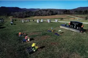  ?? LIZ DUFOUR/CINCINNATI ENQUIRER ?? The Rhoden burial site in Mcdermott sits atop a rolling hill about 20 miles south of where family members were killed in their homes in April 2016. The five Rhodens lived at three different addresses on Union Hill Road in Peebles.