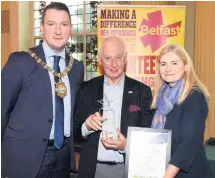  ??  ?? Lord Mayor John Finucane and Siobhan Toland of Belfast City Council with Colin Flinn, winner of the Marie Mathews Participat­ion Award at this year’s Age-friendly Older Volunteer of the Year Awards at Belfast City Hall