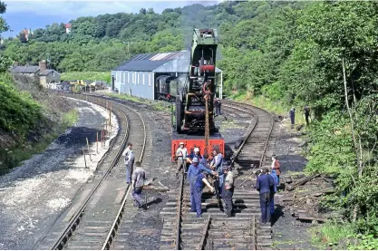  ?? ?? ABOVE NELPG and SVR volunteers using the NRM’s NER steam crane lay the final turnout into Deviation shed at Grosmont in August 1980.
