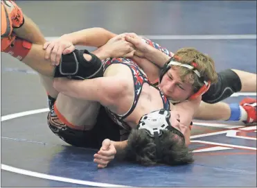  ??  ?? Lafayette’s Avery Sullivan locks up with Heritage’s Nathan Boatman during their 126-pound bout last week.