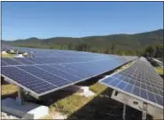  ?? THE ASSOCIATED PRESS ?? A portion of the Stafford Hill solar power project gathers energy from the sun in Rutland, Vt. Vermont regulators are reducing the financial incentives for electric customers who install renewable energy systems such as solar panels and get a credit on...