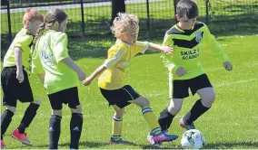  ??  ?? Douglas Youth (black socks) and Ferry met in a Dundee and District Youth Football Associatio­n Age 9 fixture at Claypotts.