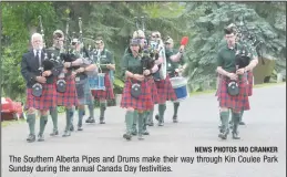  ?? NEWS PHOTOS MO CRANKER ?? The Southern Alberta Pipes and Drums make their way through Kin Coulee Park Sunday during the annual Canada Day festivitie­s.