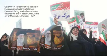  ?? — AFP ?? Government supporters hold posters of Iran’s supreme leader Ayatollah Ali Khamenei during a rally after authoritie­s declared the end of deadly unrest, in the city of Mashhad on Thursday.