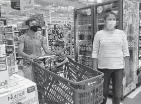  ?? Renuka Rayasam/Tribune News Service ?? Rosa Viridiana Ceron Alpizar takes her family grocery shopping. The family is among thousands of people living in dozens of recently built Juarez shelters.