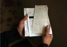  ?? New York Times photos ?? At his home in Tipton, England, on Nov. 11, Shafiq Rasul displays letters he wrote home while he was held at the U.S. military prison at Guantanamo Bay, Cuba.